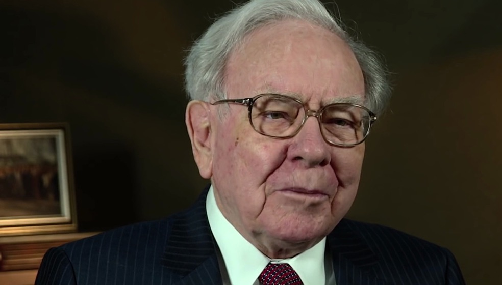 Bild von Warren Buffet in schwarzem Sakko mit weißem Hemd darunter und roter Krawatte